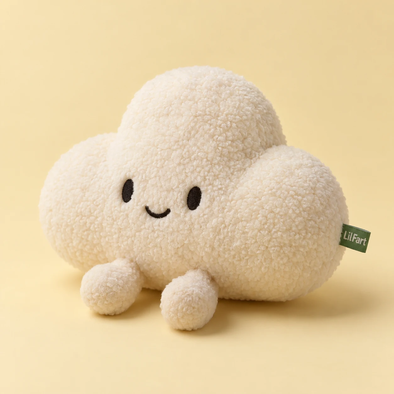 The original cream LilFart puff plush with embroidered eyes and a green woven label